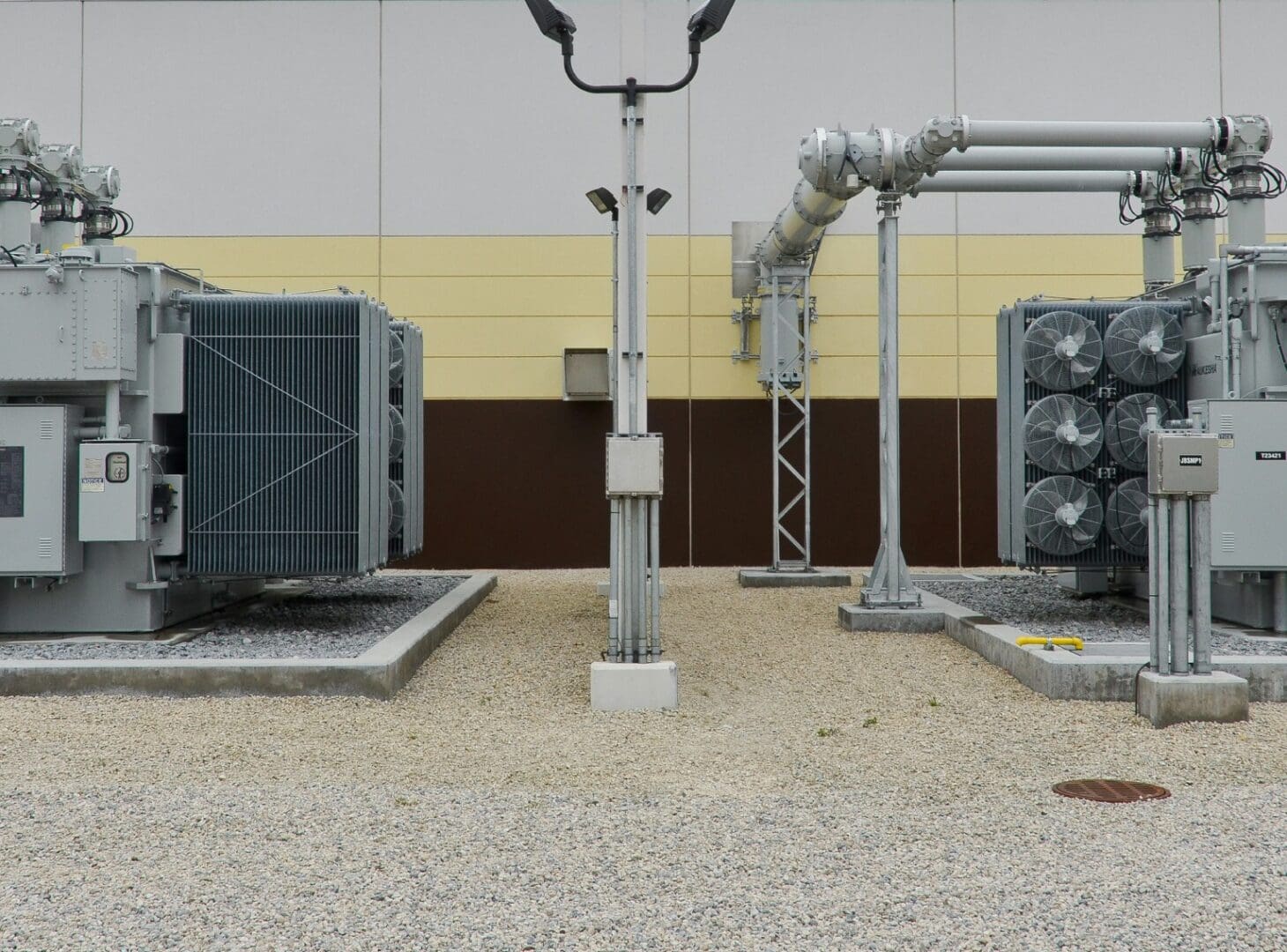 A power plant with two large fans and one small fan.