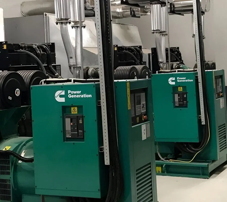 A group of generators in a room with wires.