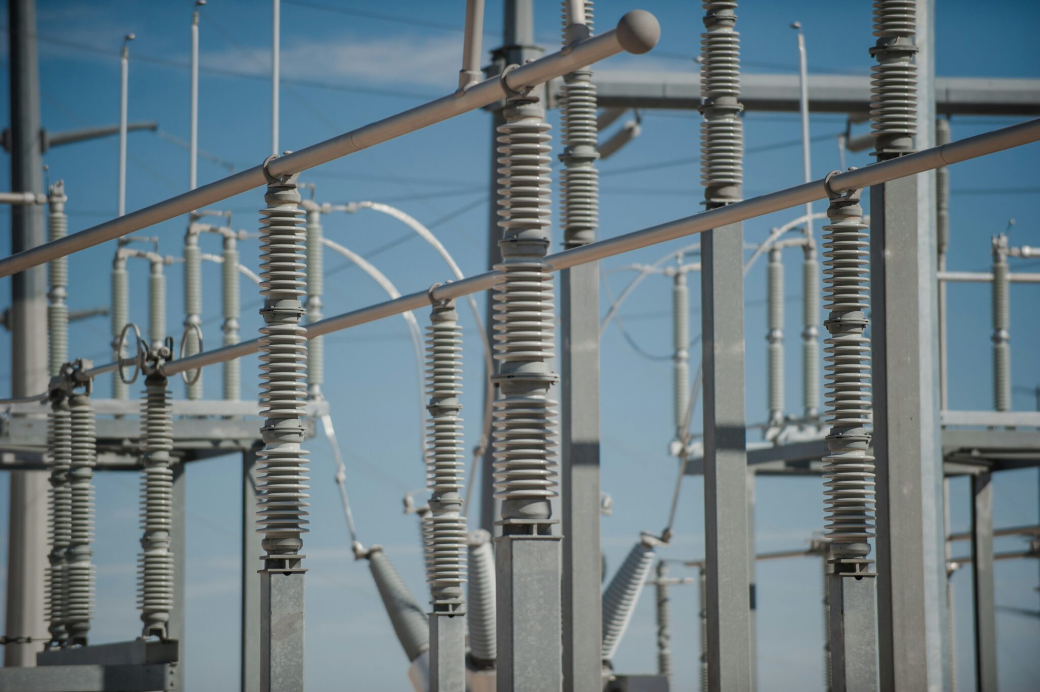 A close up of some electrical wires and poles