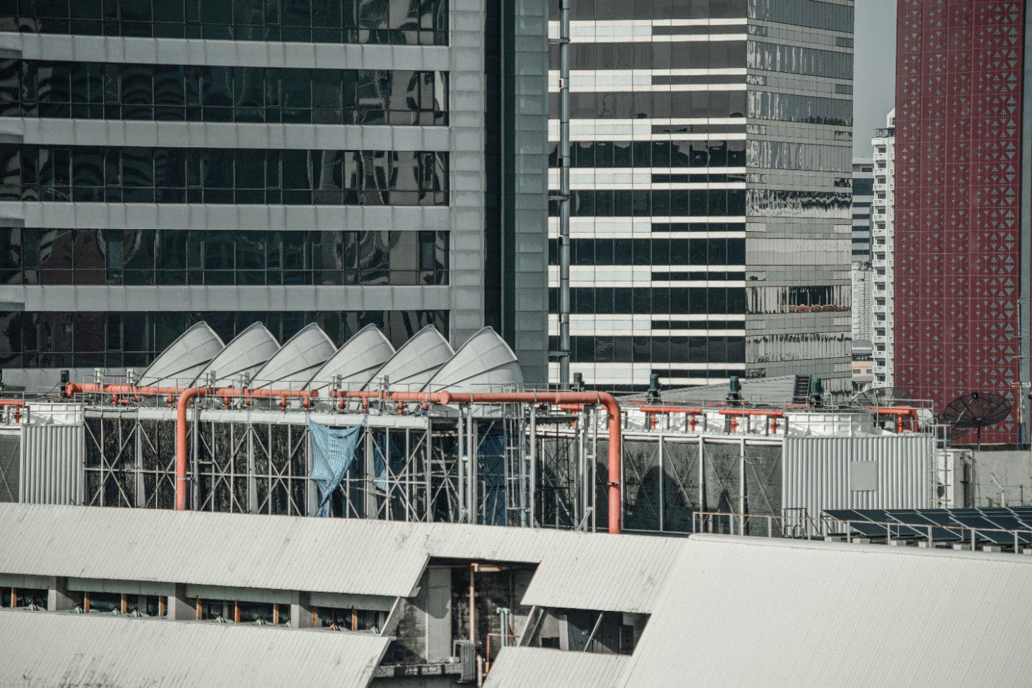 A building with many windows and a metal fence.