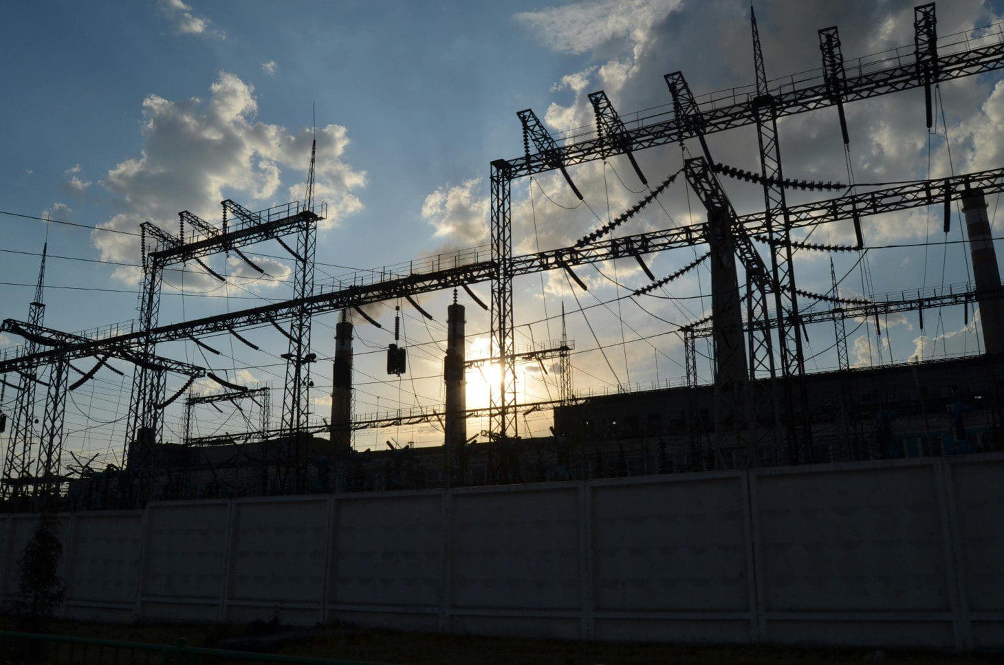 A view of power lines and the sun setting.