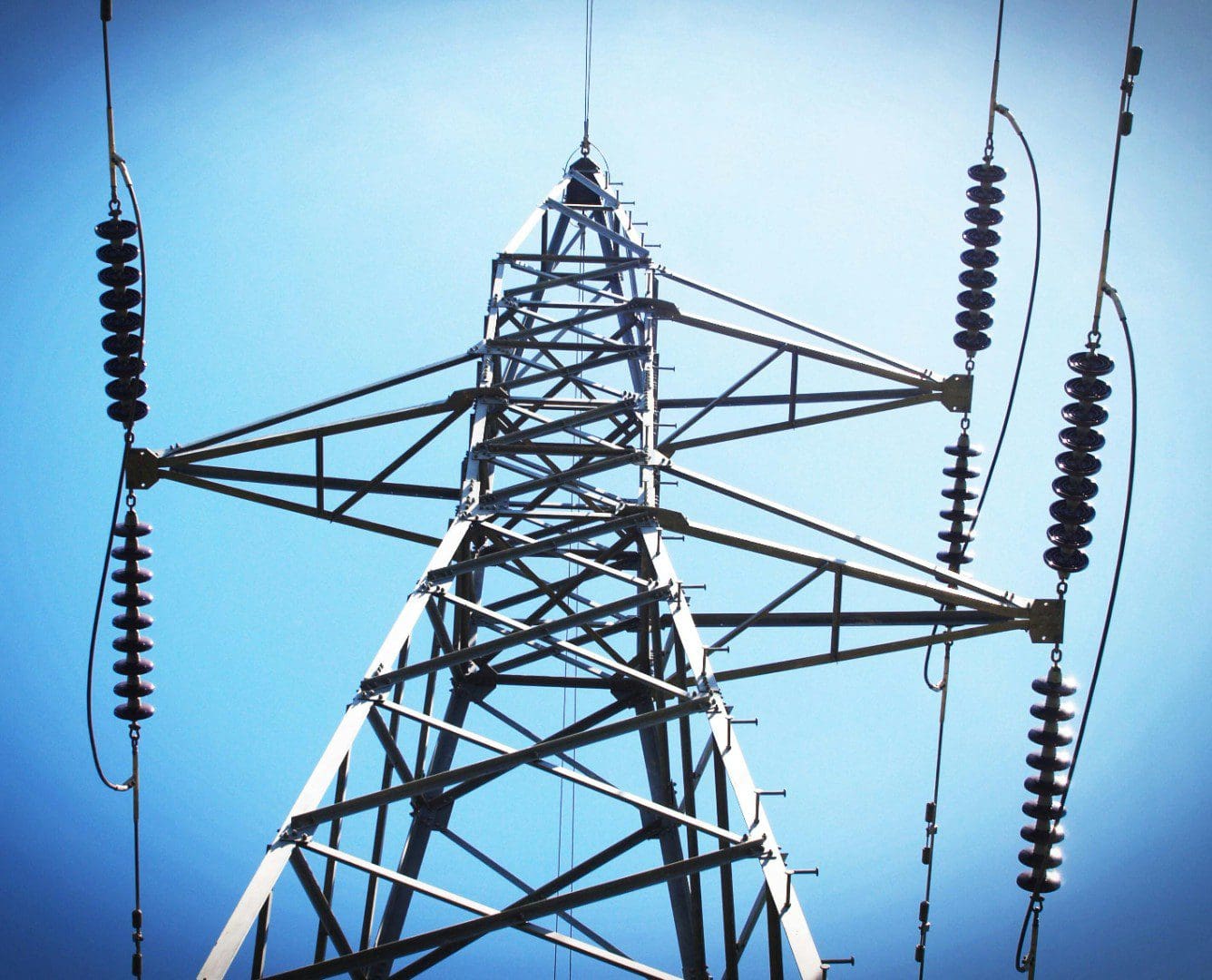 A power line tower with many wires on it.