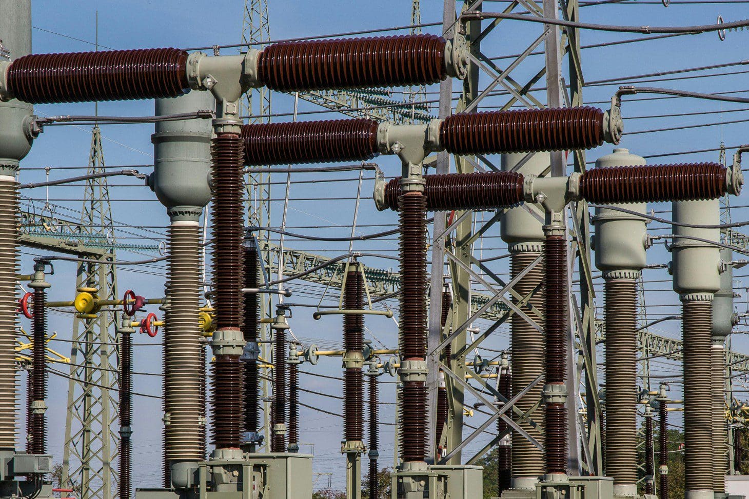 A power plant with many electrical lines and poles.