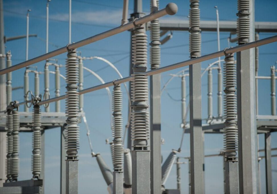 A close up of some electrical wires and poles