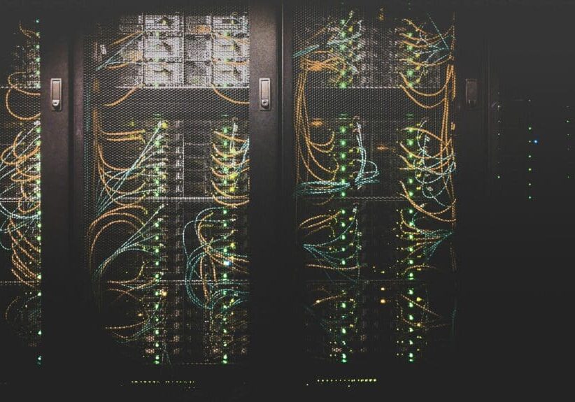 A bunch of wires are connected to the back of a cabinet